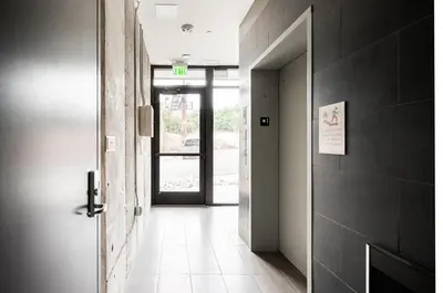 a hallway with an open door and a door sidx sidx sidx at Gameday Oasis - Private Balcony - Jefferson Park - Tesoro in Denver