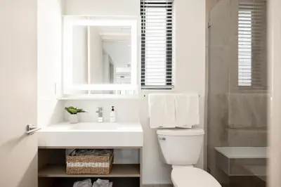 a white bathroom with a sink and a mirror at Contemporary Condo - Grill - Balcony - Tesoro in Denver