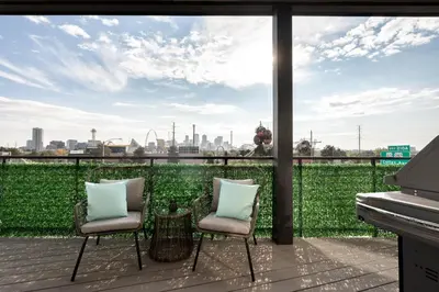 two chairs on a balcony with a view of the city at Contemporary Condo - Grill - Balcony - Tesoro in Denver