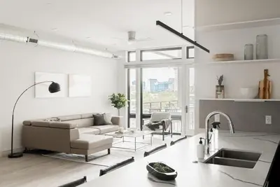 a living room with a couch and a table at Luxurious Escape - Walk to Empower Field - Tesoro in Denver