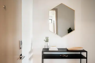 a bathroom with a black vanity and a mirror at Brand New Condo - Walk to Empower Stadium - Tesoro in Denver