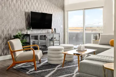 a living room with a couch and a tv at New! Sprawling Floor Plan - Central LoHi - Peloton in Denver