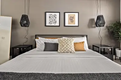 a bedroom with a large white bed with pillows at New! Sprawling Floor Plan - Central LoHi - Peloton in Denver