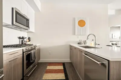 a kitchen with a sink and a stove at New! Sprawling Floor Plan - Central LoHi - Peloton in Denver