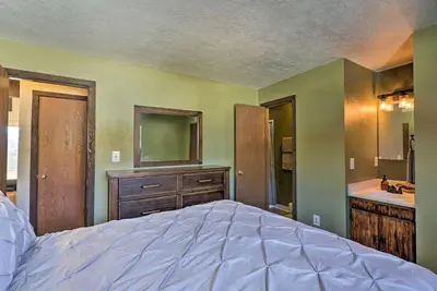 a bedroom with a bed and a bathroom with a sink at Mtn-View Silverthorne Gem with Shared Hot Tub in Silverthorne