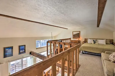 a bedroom with a bed and a staircase in a room at Mtn-View Silverthorne Gem with Shared Hot Tub in Silverthorne