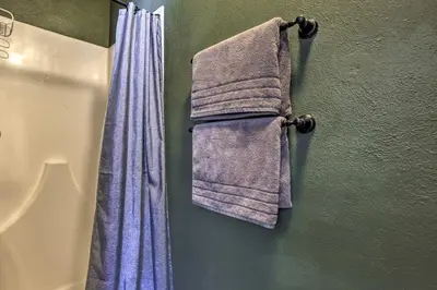 a towel hanging on a wall next to a curtain at Mtn-View Silverthorne Gem with Shared Hot Tub in Silverthorne