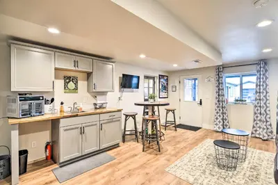 a kitchen with white cabinets and a table and chairs at Relaxing Loveland Escape with Mountain Views in Loveland