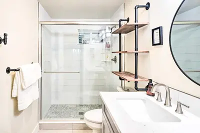 a white bathroom with a shower and a sink at Relaxing Loveland Escape with Mountain Views in Loveland