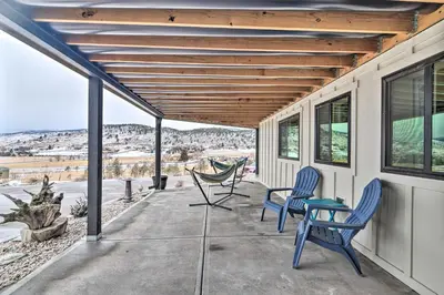 a patio with two chairs and a table on a house at Relaxing Loveland Escape with Mountain Views in Loveland