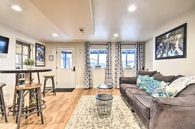 a living room with a couch and a table at Relaxing Loveland Escape with Mountain Views in Loveland