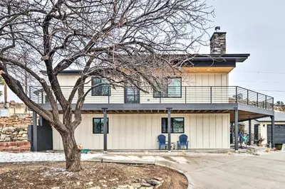 a house with two blue chairs and a tree at Relaxing Loveland Escape with Mountain Views in Loveland