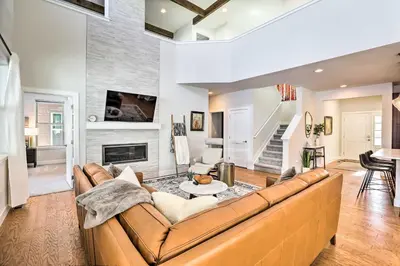 a living room with a couch and a fireplace at Hike and Ski Stunning Home with Hot Tub in Granby! in Granby