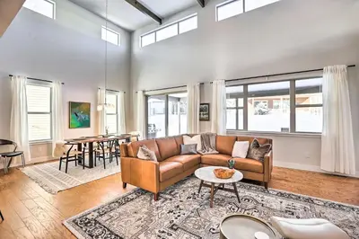 a living room with a couch and a table at Hike and Ski Stunning Home with Hot Tub in Granby! in Granby