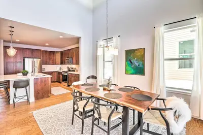 a kitchen and dining room with a wooden table and chairs at Hike and Ski Stunning Home with Hot Tub in Granby! in Granby