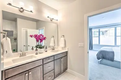 a bathroom with a sink and a large mirror at Hike and Ski Stunning Home with Hot Tub in Granby! in Granby