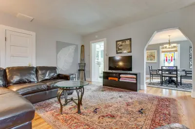 a living room with a couch and a table at 2 Mi to Washington Park Convenient Denver Home! in Denver