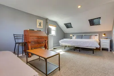 a bedroom with a bed and a desk and a chair at 2 Mi to Washington Park Convenient Denver Home! in Denver
