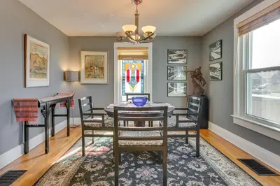 a dining room with a table and chairs and a stained glass window at 2 Mi to Washington Park Convenient Denver Home! in Denver