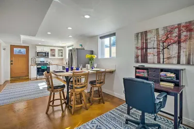 a kitchen with a table and chairs in a room at 4 Mi to Coors Field Charming Apartment with Patio in Denver