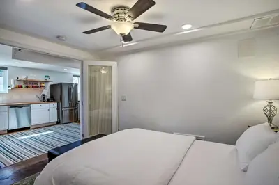 a bedroom with a bed and a ceiling fan at 4 Mi to Coors Field Charming Apartment with Patio in Denver