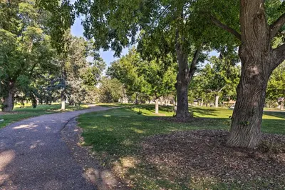 a path in a park with trees and grass at 4 Mi to Coors Field Charming Apartment with Patio in Denver