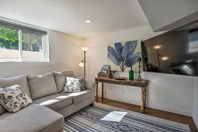 a living room with a couch and a table at 4 Mi to Coors Field Charming Apartment with Patio in Denver