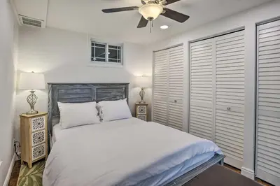 a bedroom with a bed and a ceiling fan at 4 Mi to Coors Field Charming Apartment with Patio in Denver