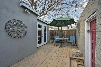 a patio with a table and a green umbrella at Platt Park Studio with Patio Walkable Location! in Denver