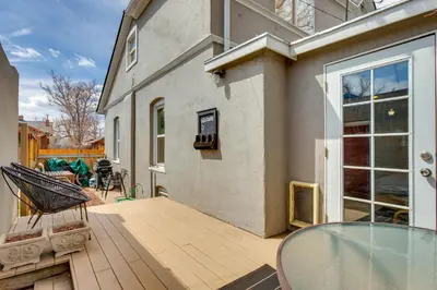 a patio with a glass table and a house at Platt Park Studio with Patio Walkable Location! in Denver
