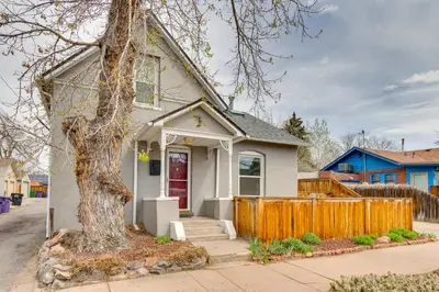 a white house with a tree in front of it at Platt Park Studio with Patio Walkable Location! in Denver