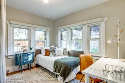 a bedroom with windows and a bed and a desk at Stay and Play in South Denver! 7 Mi to LoDo in Denver
