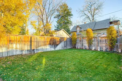 a fence in a yard next to a house at Stay and Play in South Denver! 7 Mi to LoDo in Denver