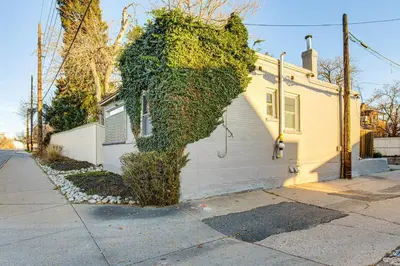 a building covered in ivy next to a house at Stay and Play in South Denver! 7 Mi to LoDo in Denver