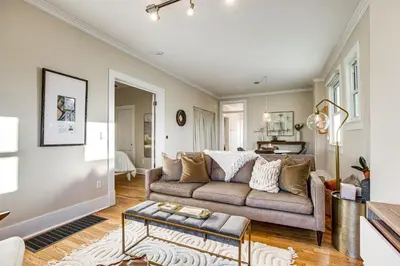 a living room with a couch and a table at Stay and Play in South Denver! 7 Mi to LoDo in Denver