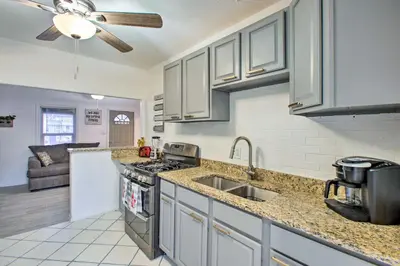 a kitchen with a sink and a stove top oven at Walk to Tennyson St! Pet-Friendly Denver Home in Denver