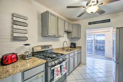 a kitchen with a stove and a counter top at Walk to Tennyson St! Pet-Friendly Denver Home in Denver