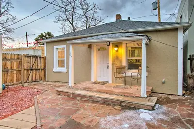 a small house with a white door and a patio at Walk to Tennyson St! Pet-Friendly Denver Home in Denver