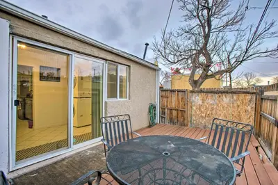 a patio with a table and chairs on a deck at Walk to Tennyson St! Pet-Friendly Denver Home in Denver
