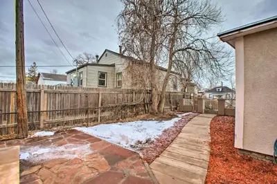 a house with a wooden fence and a sidewalk at Walk to Tennyson St! Pet-Friendly Denver Home in Denver