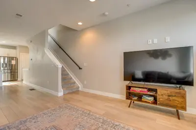 a living room with a large flat screen tv at Rooftop Deck and Hot Tub Walkable Denver Townhome in Denver