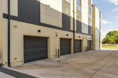 a row of garage doors on a building at Rooftop Deck and Hot Tub Walkable Denver Townhome in Denver