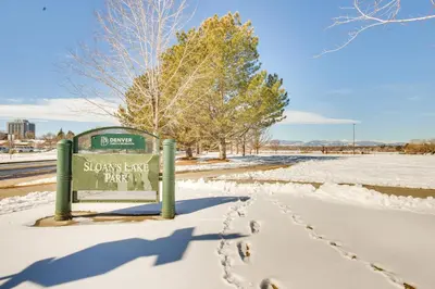a snow covered park sign with footprints in the snow at Rooftop Deck and Hot Tub Walkable Denver Townhome in Denver