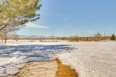 an empty parking lot with snow on the ground at Rooftop Deck and Hot Tub Walkable Denver Townhome in Denver