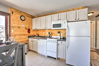 a kitchen with white appliances and a white refrigerator at Granby Studio with Mtn Views Near Hiking and Skiing! in Granby