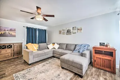 a living room with a couch and a ceiling fan at Loveland Duplex with Large Yard 2 Mi to Dtwn in Loveland