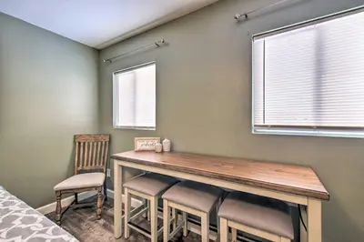 a room with a table with chairs and a window at Loveland Duplex with Large Yard 2 Mi to Dtwn in Loveland