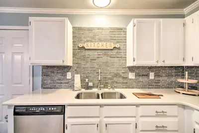 a kitchen with white cabinets and a sink at Loveland Duplex with Large Yard 2 Mi to Dtwn in Loveland