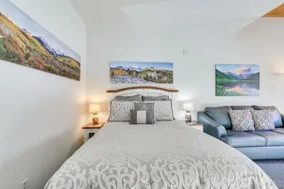 a bedroom with a bed and a couch at Walk to Lifts Studio with Hot Tub in Keystone! in Keystone