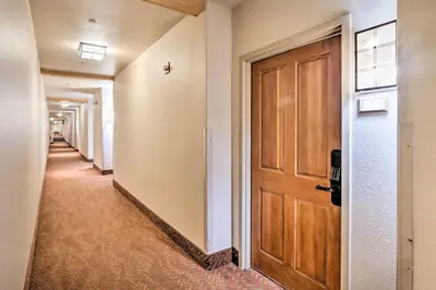 a hallway with a wooden door at Walk to Lifts Studio with Hot Tub in Keystone! in Keystone